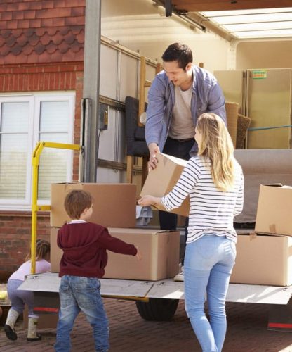 Family Unpacking Moving In Boxes From Removal Truck — Furniture Removal in Coffs Harbour, NSW